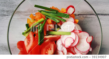 Glass bowl with cut vegetables for a vegan salad Glass bowl with cut vegetables for a vegan salad 39134907