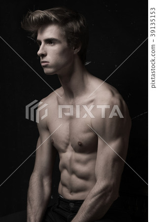 Young Handsome man portrait at dark background Young Handsome man portrait at dark background 39135153