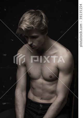 Young Handsome man portrait at dark background Young Handsome man portrait at dark background 39135154