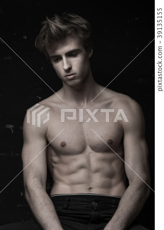 Young Handsome man portrait at dark background Young Handsome man portrait at dark background 39135155