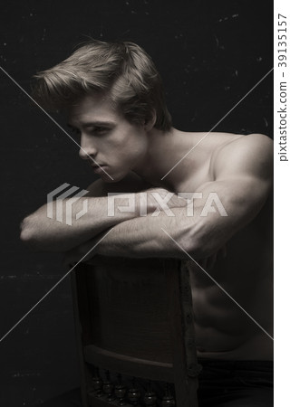 Young Handsome man portrait at dark background Young Handsome man portrait at dark background 39135157