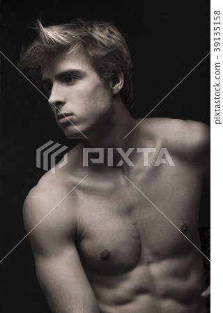 Young Handsome man portrait at dark background Young Handsome man portrait at dark background 39135158