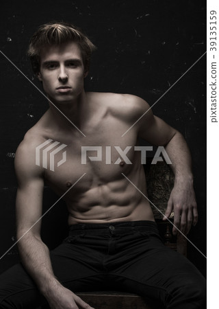 Young Handsome man portrait at dark background Young Handsome man portrait at dark background 39135159