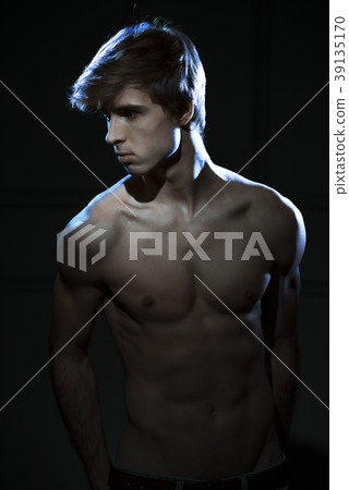 Young Handsome man portrait at dark background Young Handsome man portrait at dark background 39135170