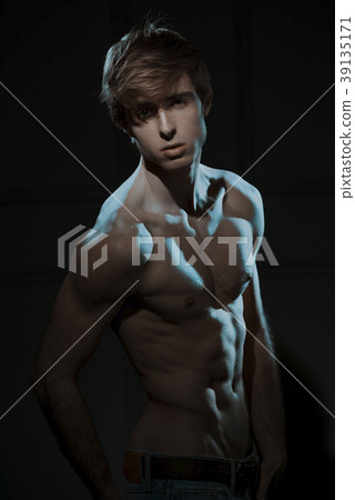 Young Handsome man portrait at dark background Young Handsome man portrait at dark background 39135171
