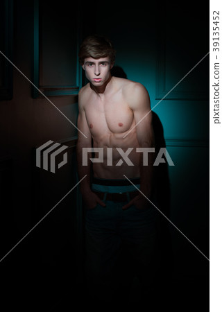 Young Handsome man portrait at dark background Young Handsome man portrait at dark background 39135452