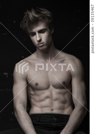 Young Handsome man portrait at dark background Young Handsome man portrait at dark background 39135467