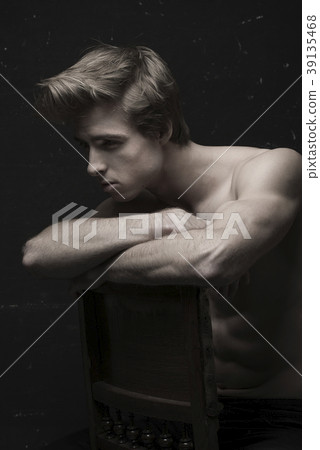 Young Handsome man portrait at dark background 39135468