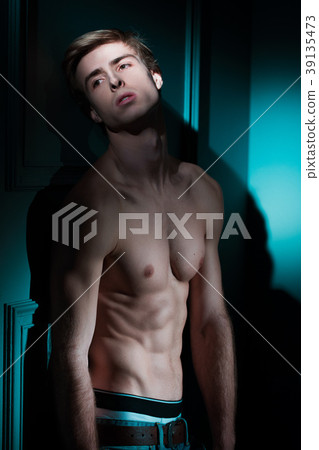 Young Handsome man portrait at dark background Young Handsome man portrait at dark background 39135473