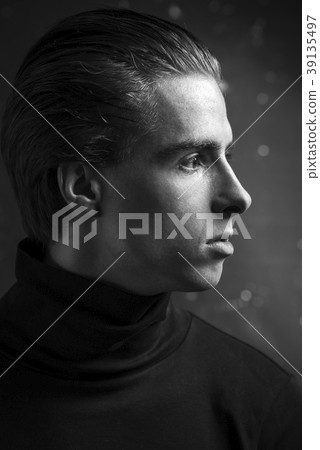 Young Handsome man portrait at dark background Young Handsome man portrait at dark background 39135497