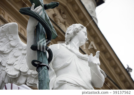 Angel statue with cross, Karlskirche in Vienna Angel statue with cross, Karlskirche in Vienna 39137562