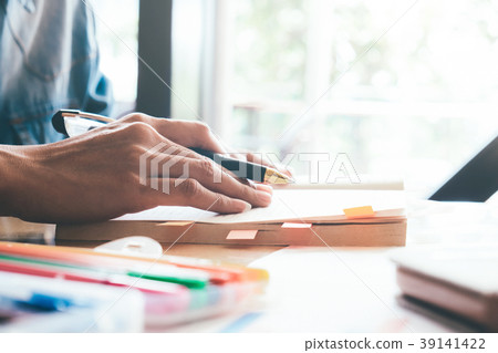 Student reading a book on in library. 39141422