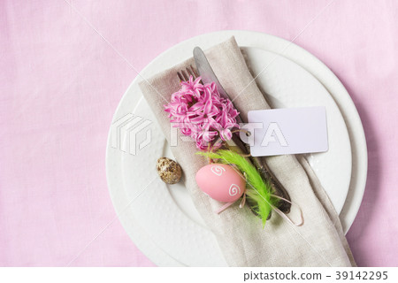 Easter table setting on pink tablecloth. Top view. Easter table setting on pink tablecloth. Top view. 39142295
