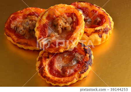 Mini pizza topped with cherry tomatoes and capers Mini pizza topped with cherry tomatoes and capers 39144253