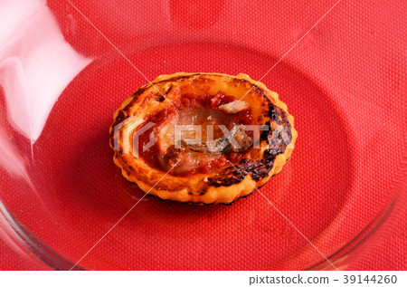 Mini pizza topped with cherry tomatoes and capers 39144260