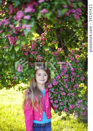 Pretty smiling girl in pink blossom garden. 39145413