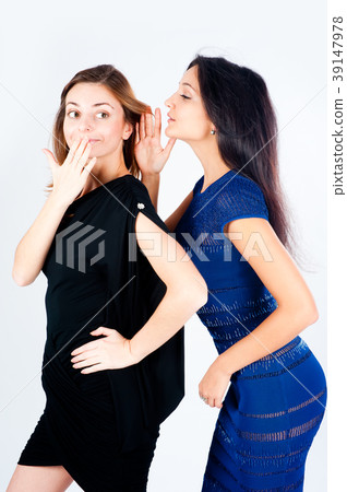 Two gossiping girlfriends 39147978