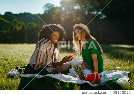 Happy picnic of two multi-race girl friends 39150053