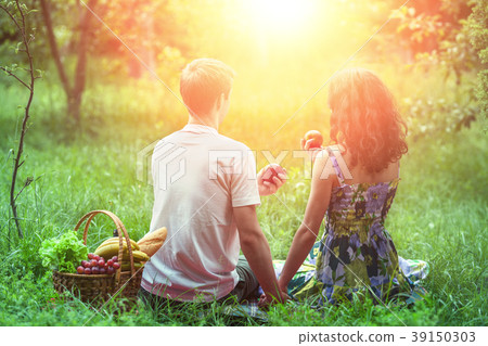 Young couple with kitten in a basket at a picnic Young couple with kitten in a basket at a picnic 39150303