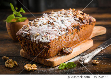 Sweet cake baked with dates, nuts 39150488