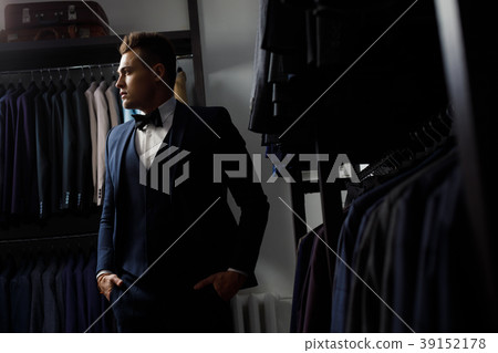 client is elegant guy trying on a suit in a mirror 39152178