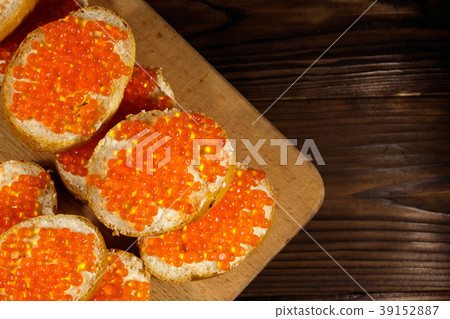 Sandwiches with butter and red caviar on wooden ta Sandwiches with butter and red caviar on wooden ta 39152887
