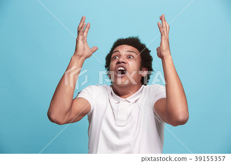 The young emotional angry man screaming on blue 39155357