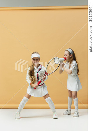 Portrait of two girls as tennis players holding Portrait of two girls as tennis players holding 39155644