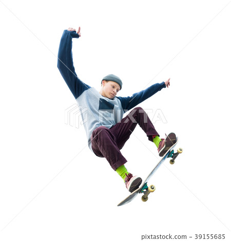 A teenager skateboarder jumps an ollie on an 39155685
