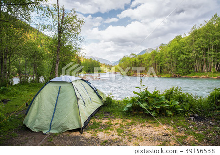 Tourist tent on the bank of a mountain river Tourist tent on the bank of a mountain river 39156538
