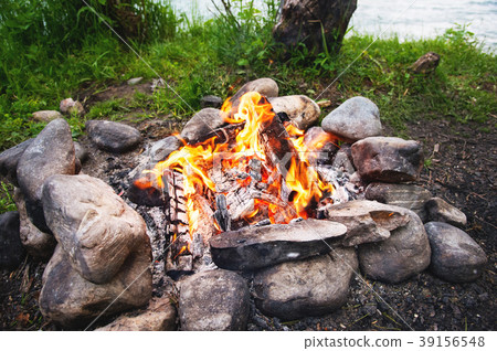 A hot fire with red burning coals in a stone 39156548