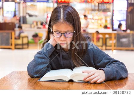 Asian teenager girl spending time reading her book Asian teenager girl spending time reading her book 39158783