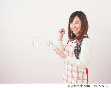 Smiling woman holding a calculator 39159767