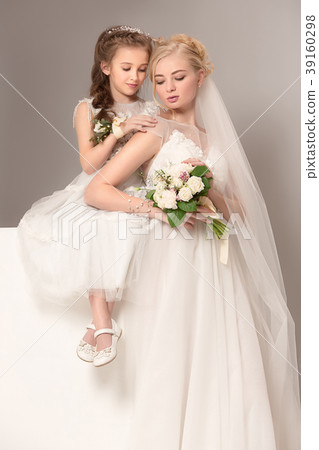 Little pretty girls with flowers dressed in 39160298