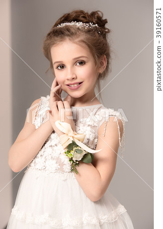 Little pretty girl with flowers dressed in wedding Little pretty girl with flowers dressed in wedding 39160571