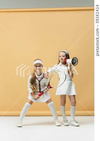 Portrait of two girls as tennis players holding Portrait of two girls as tennis players holding 39161414