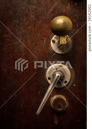 closeup of brown wooden door lock and knob 39162001