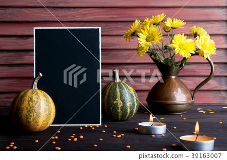 Black board, pumpkin and copper jug 39163007