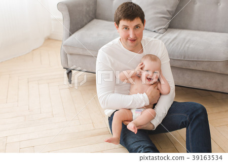 Happy father with cheerful infant on hands Happy father with cheerful infant on hands 39163534
