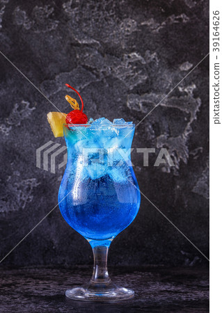 Blue Curacao cocktail decorated with fruit. 39164626