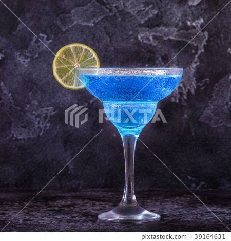 Blue Curacao cocktail decorated with fruit. 39164631