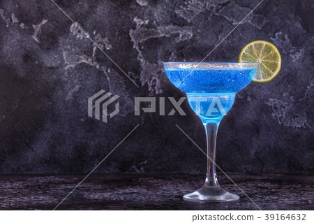 Blue Curacao cocktail decorated with fruit. 39164632