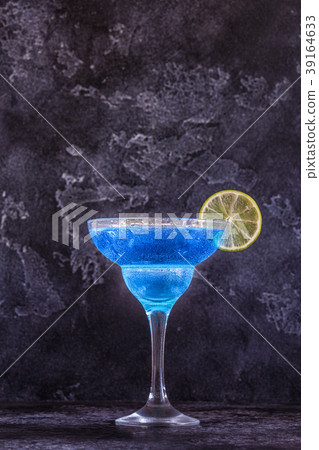 Blue Curacao cocktail decorated with fruit. 39164633