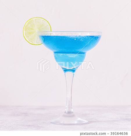 Blue Curacao cocktail decorated with fruit. 39164636