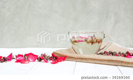 A cup of tea pink rose on a white wooden table. A cup of tea pink rose on a white wooden table. 39169160