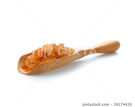 Rock sugar in wood scoop on white background Rock sugar in wood scoop on white background 39174420
