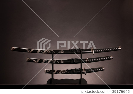 Katana, wakizashi and tanto, monochromatic lighting. Copy space. Katana, wakizashi and tanto, monochromatic lighting. Copy space. 39176645