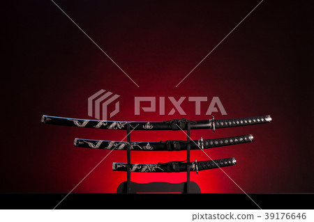 Katana, wakizashi and tanto on red background. Copy space. 39176646