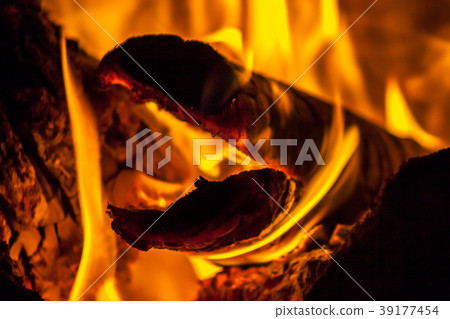 A fire burns in a fireplace A fire burns in a fireplace 39177454
