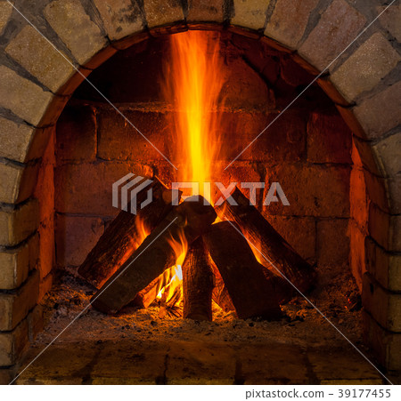 A fire burns in a fireplace A fire burns in a fireplace 39177455